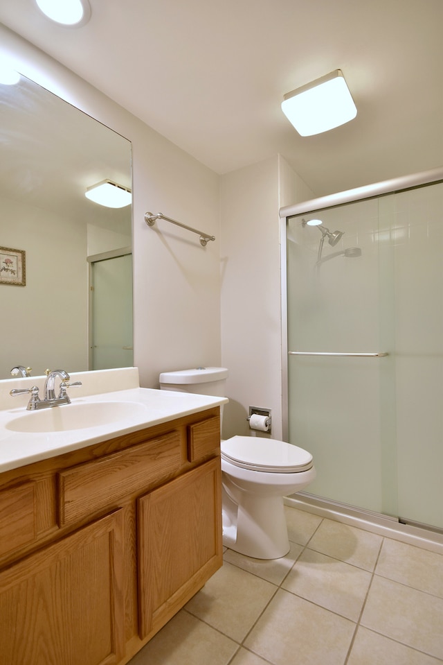 full bathroom with vanity, tile patterned floors, a stall shower, and toilet