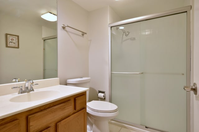 bathroom with an enclosed shower, toilet, tile patterned floors, and vanity
