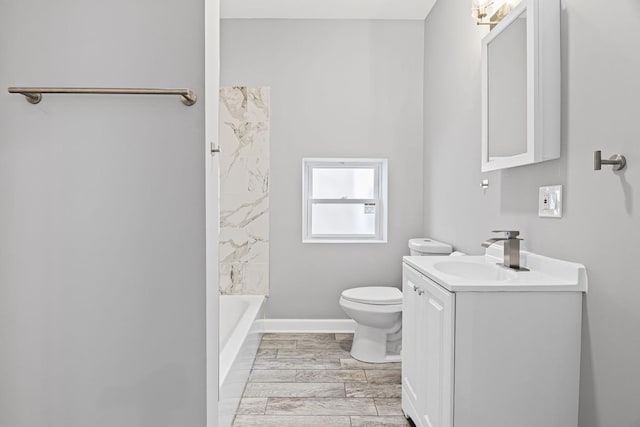 full bath with vanity, baseboards, and toilet