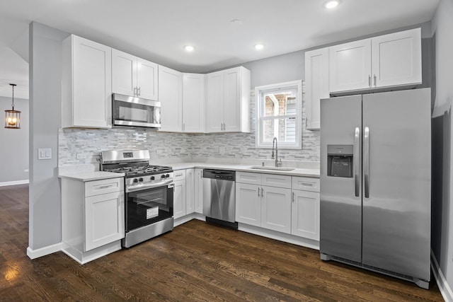 kitchen with light countertops, a sink, white cabinetry, and stainless steel appliances