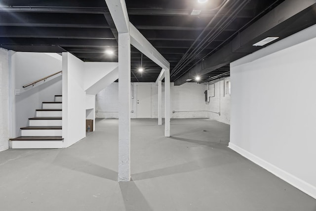 finished below grade area with baseboards and stairway