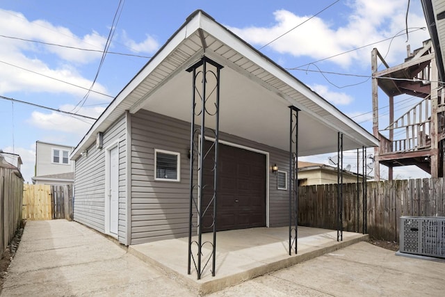 view of home's exterior with an outdoor structure, central AC unit, and fence