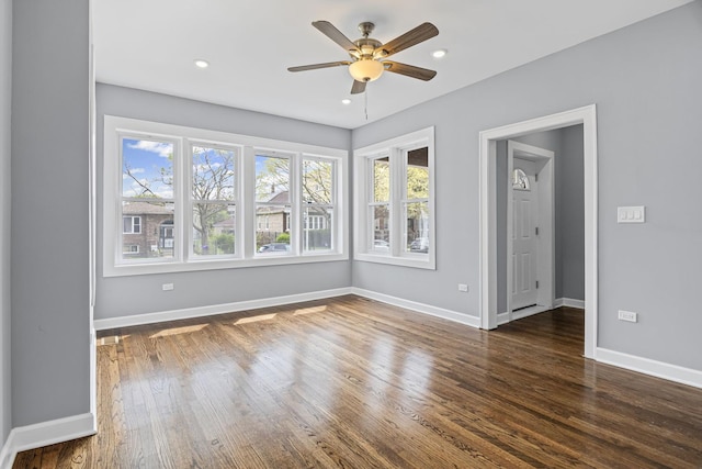 spare room with baseboards, recessed lighting, ceiling fan, and wood finished floors