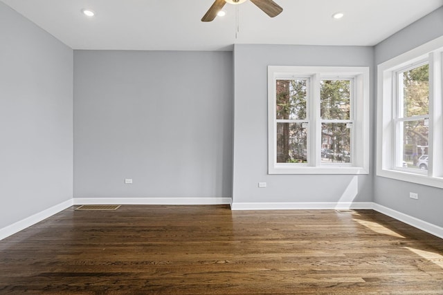 spare room with dark wood-type flooring, a ceiling fan, baseboards, and recessed lighting