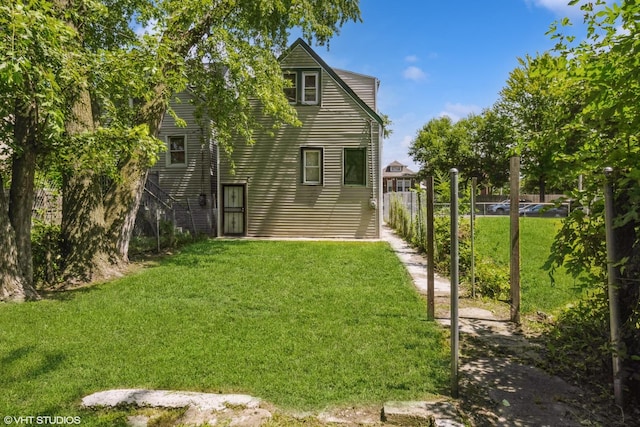 7036 S Sangamon St, Chicago, IL 60621 - back of house featuring a lawn and fence