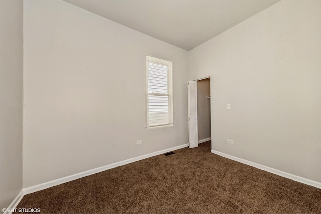 7036 S Sangamon St, Chicago, IL 60621 - unfurnished room with baseboards, lofted ceiling, dark colored carpet, and visible vents