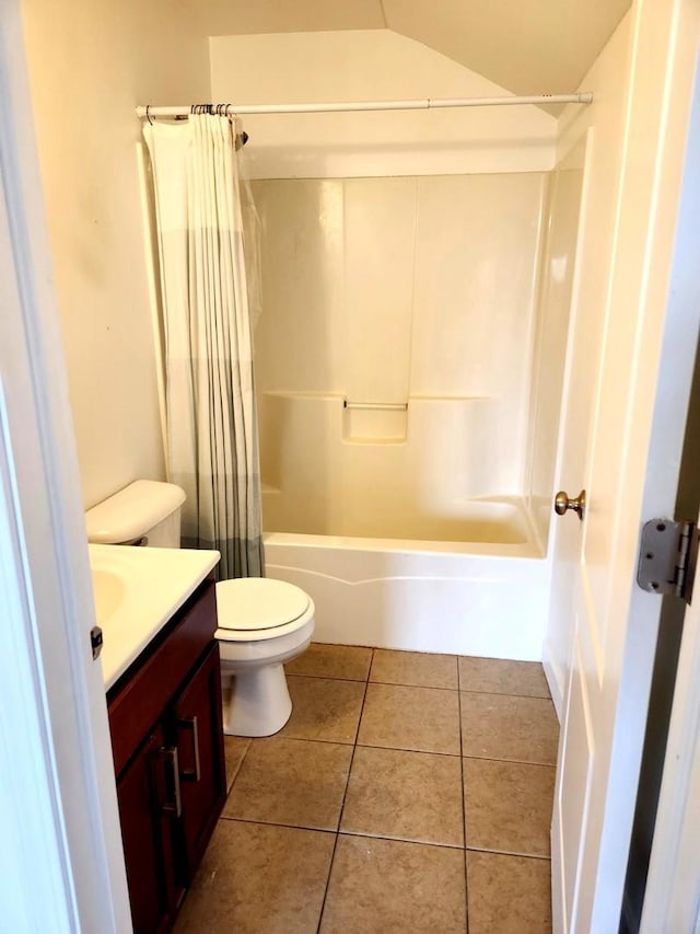 full bathroom with vanity, toilet, tile patterned floors, shower / bath combo with shower curtain, and lofted ceiling