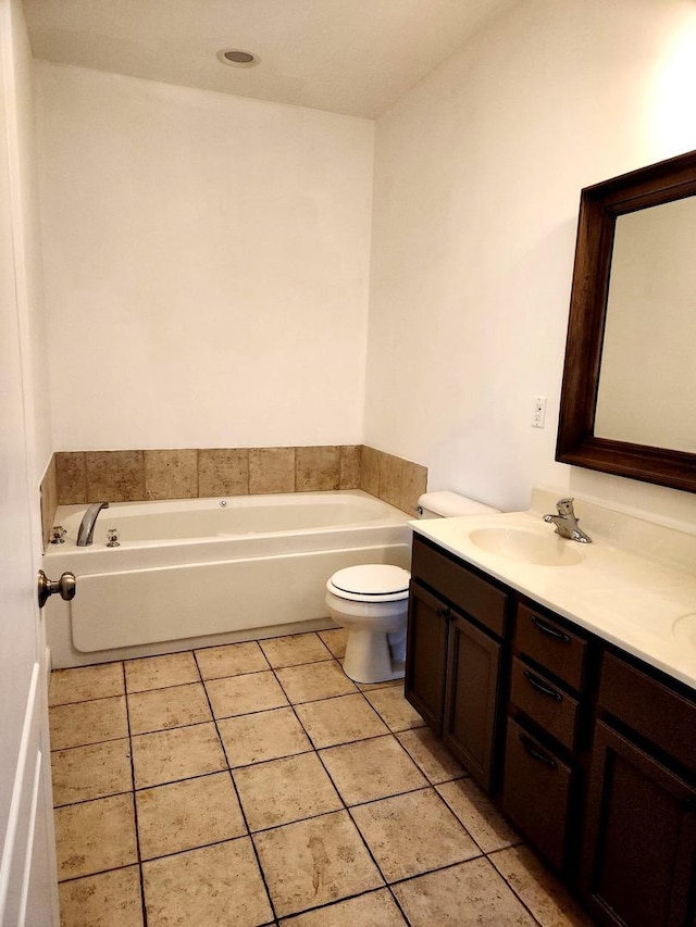 bathroom with a garden tub, double vanity, toilet, tile patterned floors, and a sink