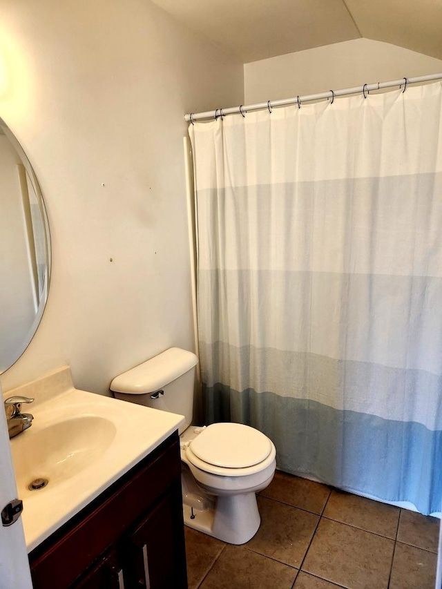 full bathroom with tile patterned flooring, vanity, curtained shower, lofted ceiling, and toilet