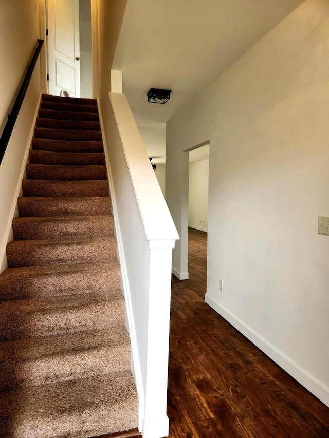 stairs with baseboards and wood finished floors