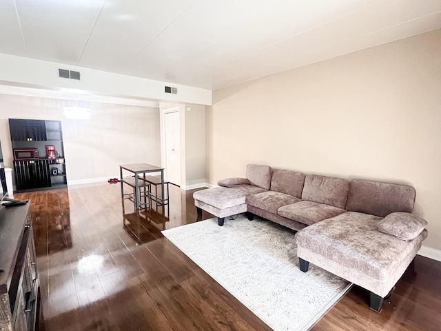 3240 N Manor Dr Unit 130, Lansing, IL 60438 - living area with baseboards, visible vents, and dark wood-type flooring