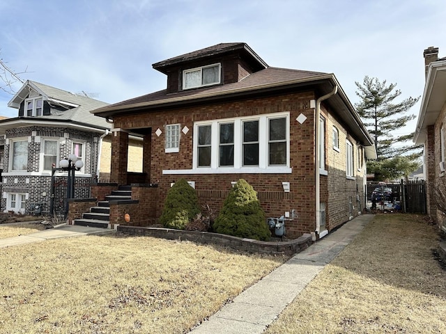 bungalow-style house featuring brick siding, a front lawn, and fence