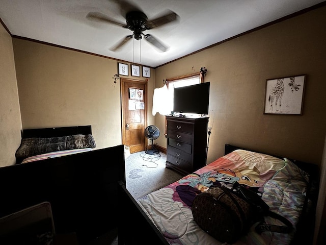 bedroom featuring crown molding, a ceiling fan, carpet flooring, and baseboards