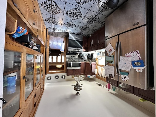 kitchen with an ornate ceiling and stainless steel fridge
