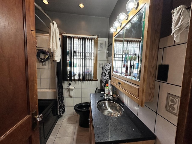 bathroom with vanity, tile patterned floors, toilet, and tile walls