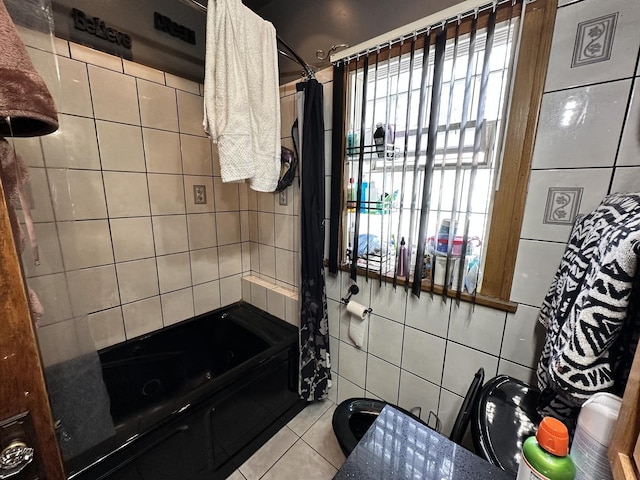 full bath with tile walls, tile patterned flooring, and shower / tub combination