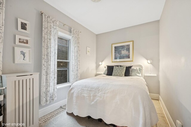 bathroom with vanity, tile walls, wainscoting, and a shower stall