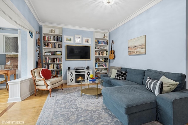 interior space featuring arched walkways, baseboards, ornamental molding, and wood finished floors