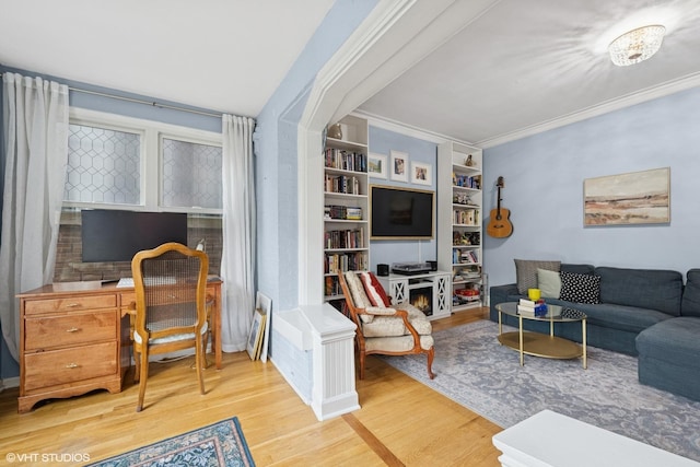 sitting room with plenty of natural light, a ceiling fan, and light wood finished floors