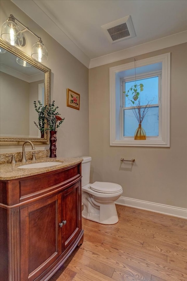 4336 N Troy St, Chicago, IL 60618 - bathroom with visible vents, wood finished floors, vanity, baseboards, and toilet