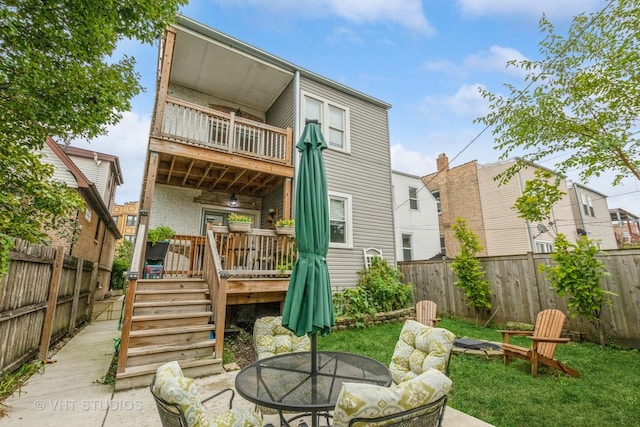 4336 N Troy St, Chicago, IL 60618 - back of house featuring a fenced backyard, a wooden deck, outdoor dining space, and a balcony