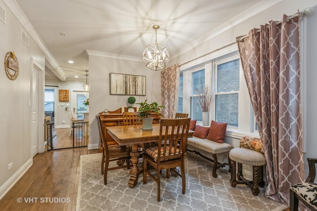 4336 N Troy St, Chicago, IL 60618 - dining area featuring visible vents, wood finished floors, a chandelier, ornamental molding, and recessed lighting
