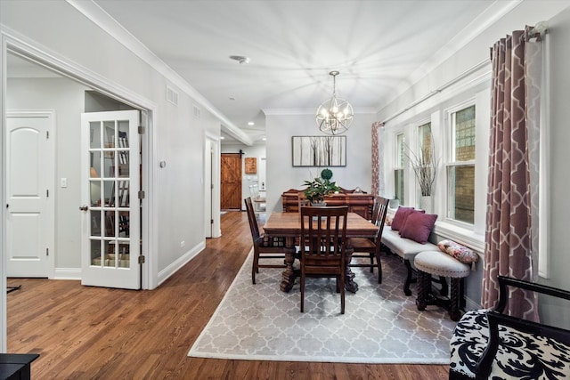 4336 N Troy St, Chicago, IL 60618 - dining room featuring baseboards, ornamental molding, wood finished floors, and visible vents