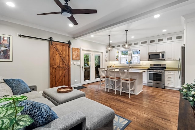 4336 N Troy St, Chicago, IL 60618 - living room featuring ceiling fan, beam ceiling, a barn door, wood finished floors, and recessed lighting