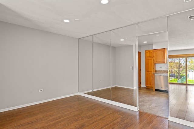704 Cobblestone Cir Unit D, Glenview, IL 60025 - unfurnished bedroom featuring recessed lighting, baseboards, visible vents, and wood finished floors