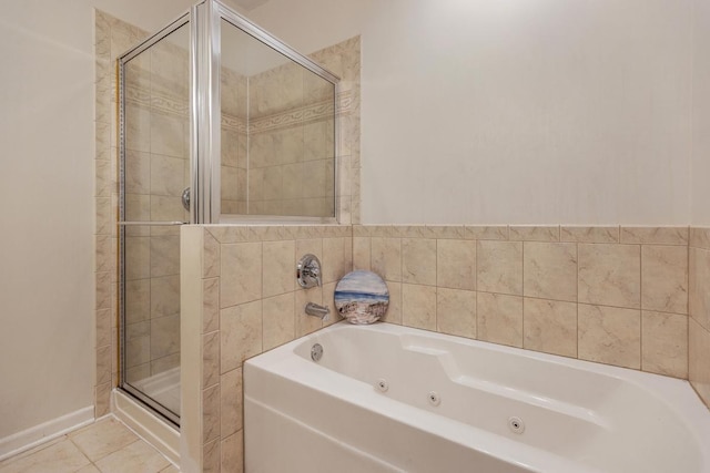 full bathroom featuring a whirlpool tub, tile patterned flooring, and a stall shower