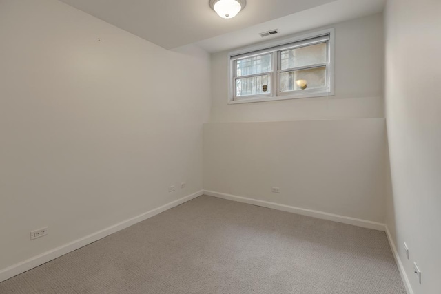 empty room with baseboards, carpet flooring, and visible vents