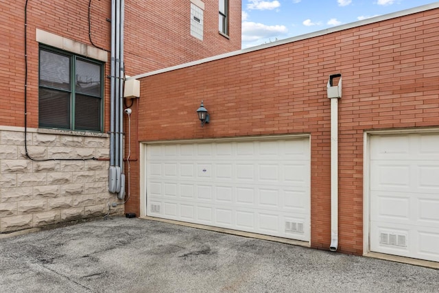 garage with aphalt driveway
