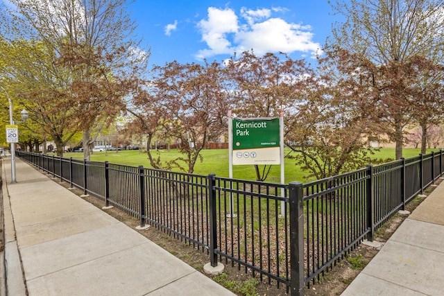 view of home's community featuring fence and a lawn