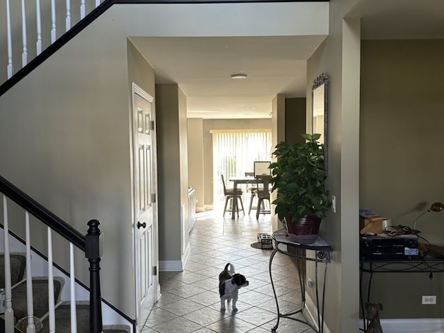 hall with stairway and baseboards
