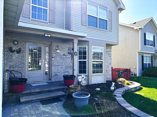 property entrance with brick siding