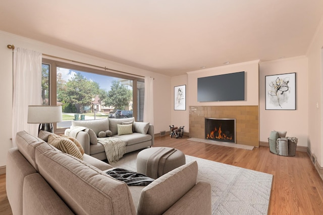 2001 Woodland Ave, Park Ridge, IL 60068 - living area with crown molding, baseboards, a lit fireplace, and wood finished floors