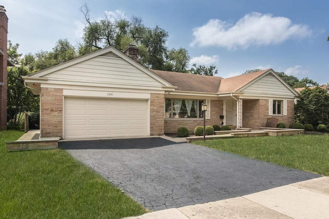 2001 Woodland Ave, Park Ridge, IL 60068 - single story home with a garage, a front lawn, a chimney, brick siding, and driveway