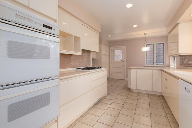 2001 Woodland Ave, Park Ridge, IL 60068 - kitchen with white appliances, light tile patterned flooring, recessed lighting, and decorative backsplash
