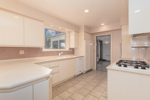 2001 Woodland Ave, Park Ridge, IL 60068 - kitchen featuring light tile patterned floors, light countertops, backsplash, and white appliances