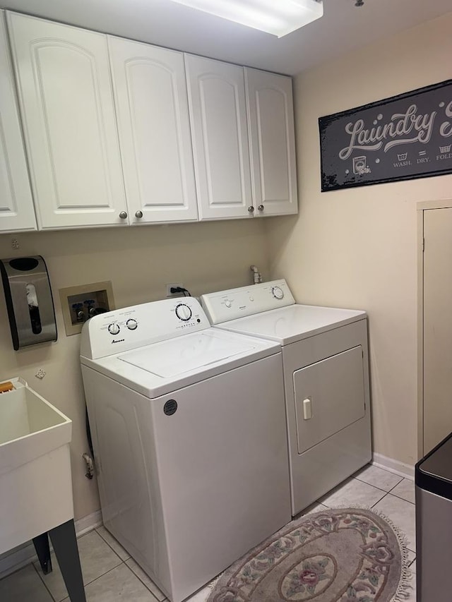 7091 W Touhy Ave Unit 509, Niles, IL 60714 - clothes washing area with independent washer and dryer, light tile patterned floors, cabinet space, and baseboards