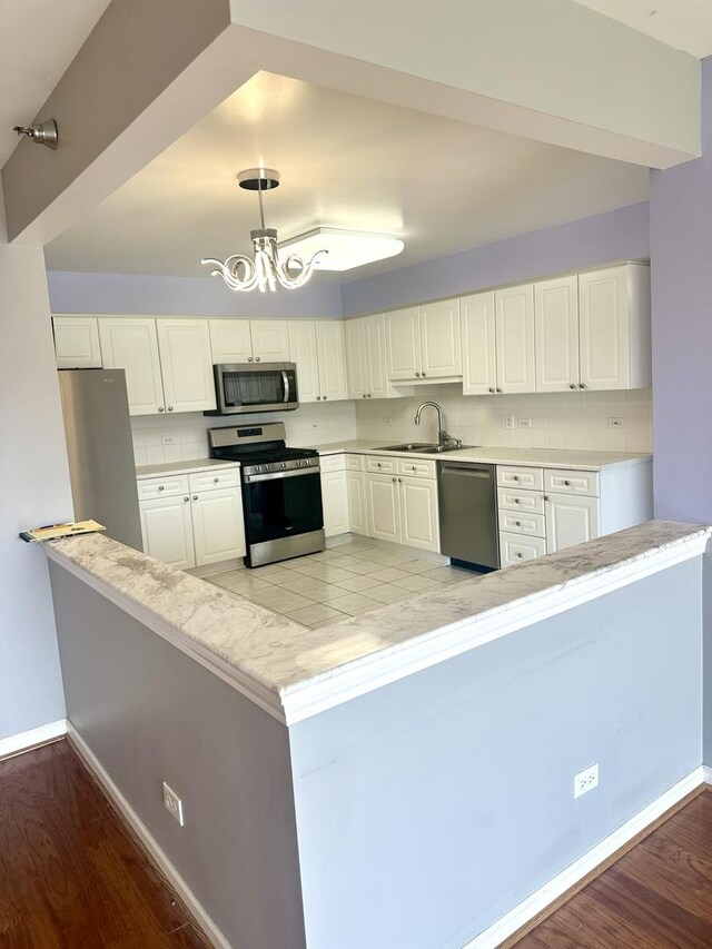 7091 W Touhy Ave Unit 509, Niles, IL 60714 - kitchen with stainless steel appliances, a sink, backsplash, and light wood-style floors