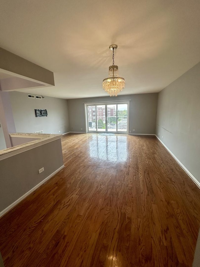 7091 W Touhy Ave Unit 509, Niles, IL 60714 - unfurnished dining area with a chandelier, wood finished floors, and baseboards