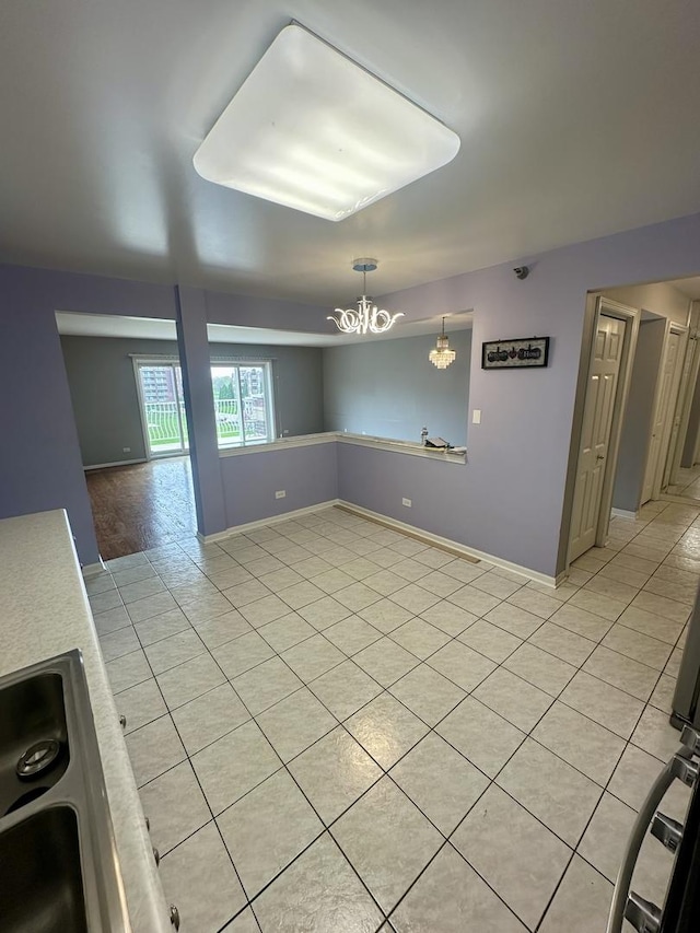 7091 W Touhy Ave Unit 509, Niles, IL 60714 - spare room featuring light tile patterned flooring, a chandelier, and baseboards