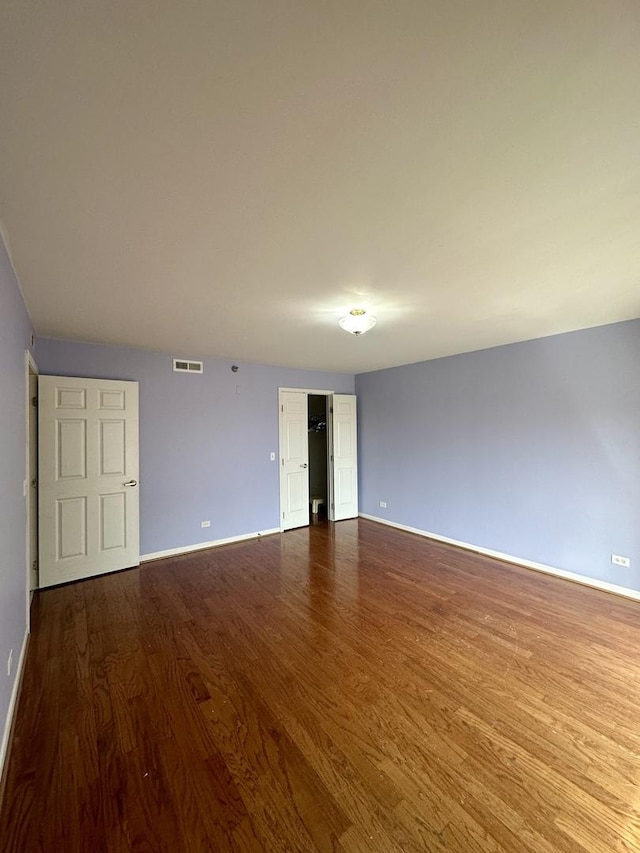 7091 W Touhy Ave Unit 509, Niles, IL 60714 - spare room featuring dark wood-style floors and baseboards