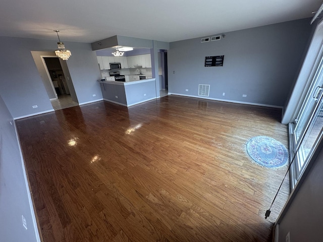 7091 W Touhy Ave Unit 509, Niles, IL 60714 - unfurnished living room with a chandelier, dark wood-style flooring, and baseboards
