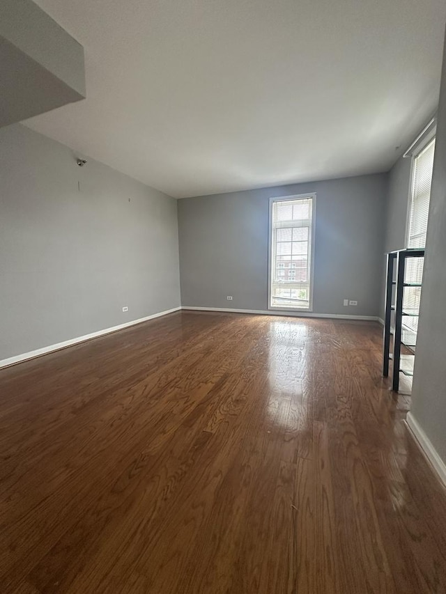 7091 W Touhy Ave Unit 509, Niles, IL 60714 - spare room featuring dark wood-type flooring and baseboards