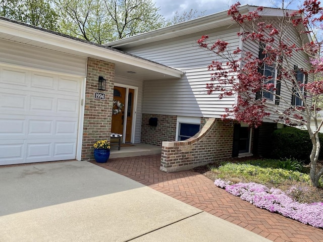 1994 Brentwood Ln, Wheaton, IL 60189 - entrance to property featuring brick siding, an attached garage, and concrete driveway