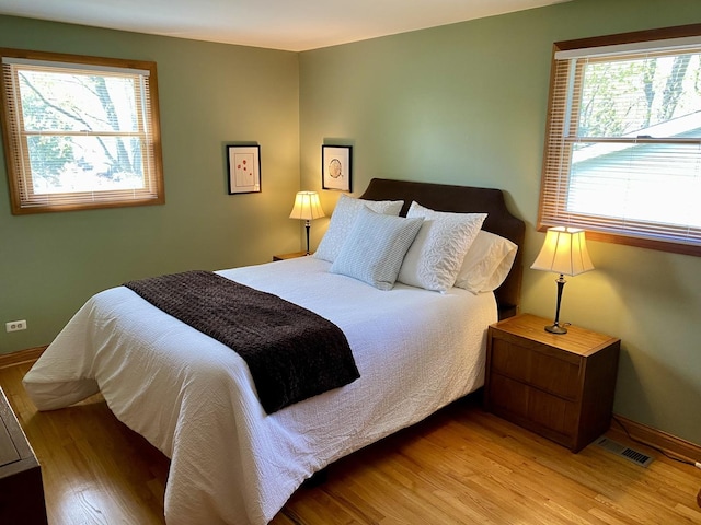 1994 Brentwood Ln, Wheaton, IL 60189 - bedroom with baseboards, multiple windows, light wood-style flooring, and visible vents
