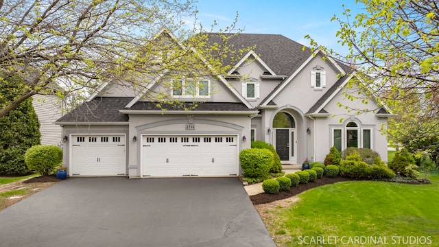 2716 Whitchurch Ct, Naperville, IL 60564 - craftsman inspired home with a garage, a front yard, stucco siding, a shingled roof, and driveway