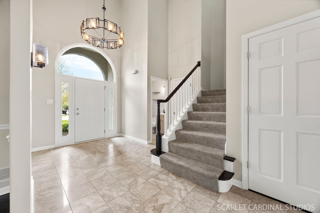 2716 Whitchurch Ct, Naperville, IL 60564 - entrance foyer featuring marble finish floor, stairs, baseboards, a high ceiling, and a chandelier